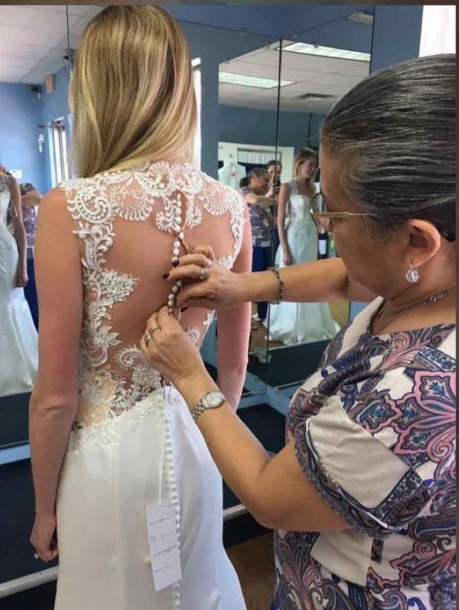 Caelina altering a bridal gown